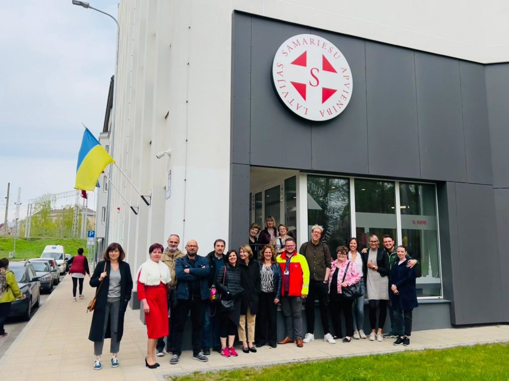 Project group poses for a group picture outside of LSA's care home in Riga.