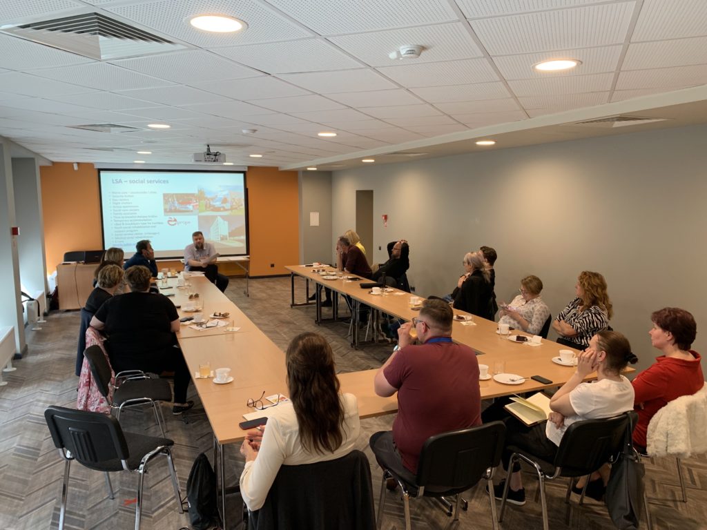 Project group listens to a presentation at the workshop in Riga.